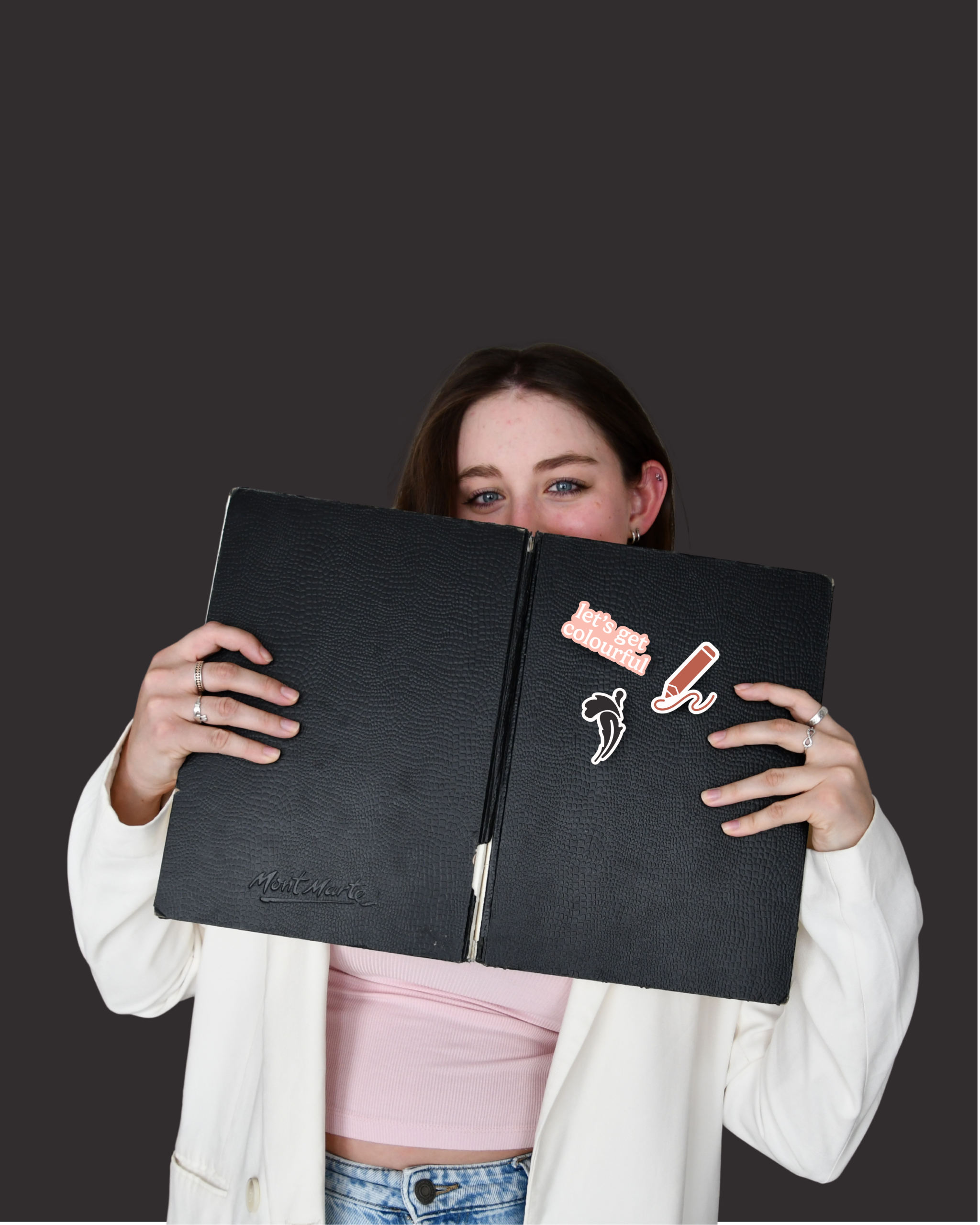 Communication designer hiding behind sketchbook